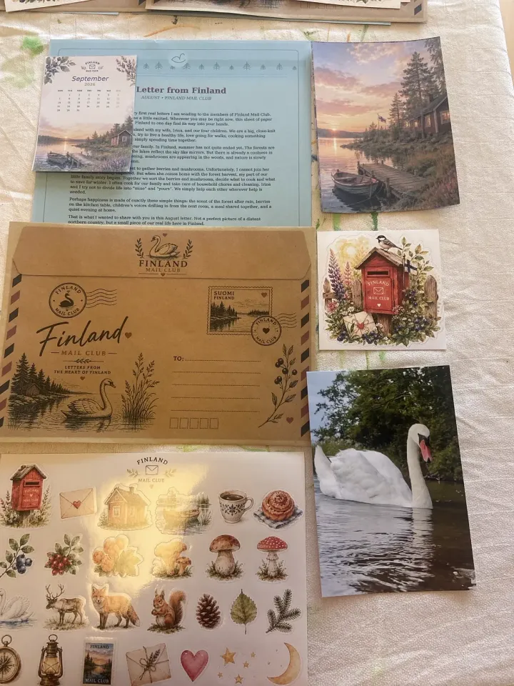 Photo of the launch edition laid out: a letter, a kraft envelope, postcards and a sticker sheet